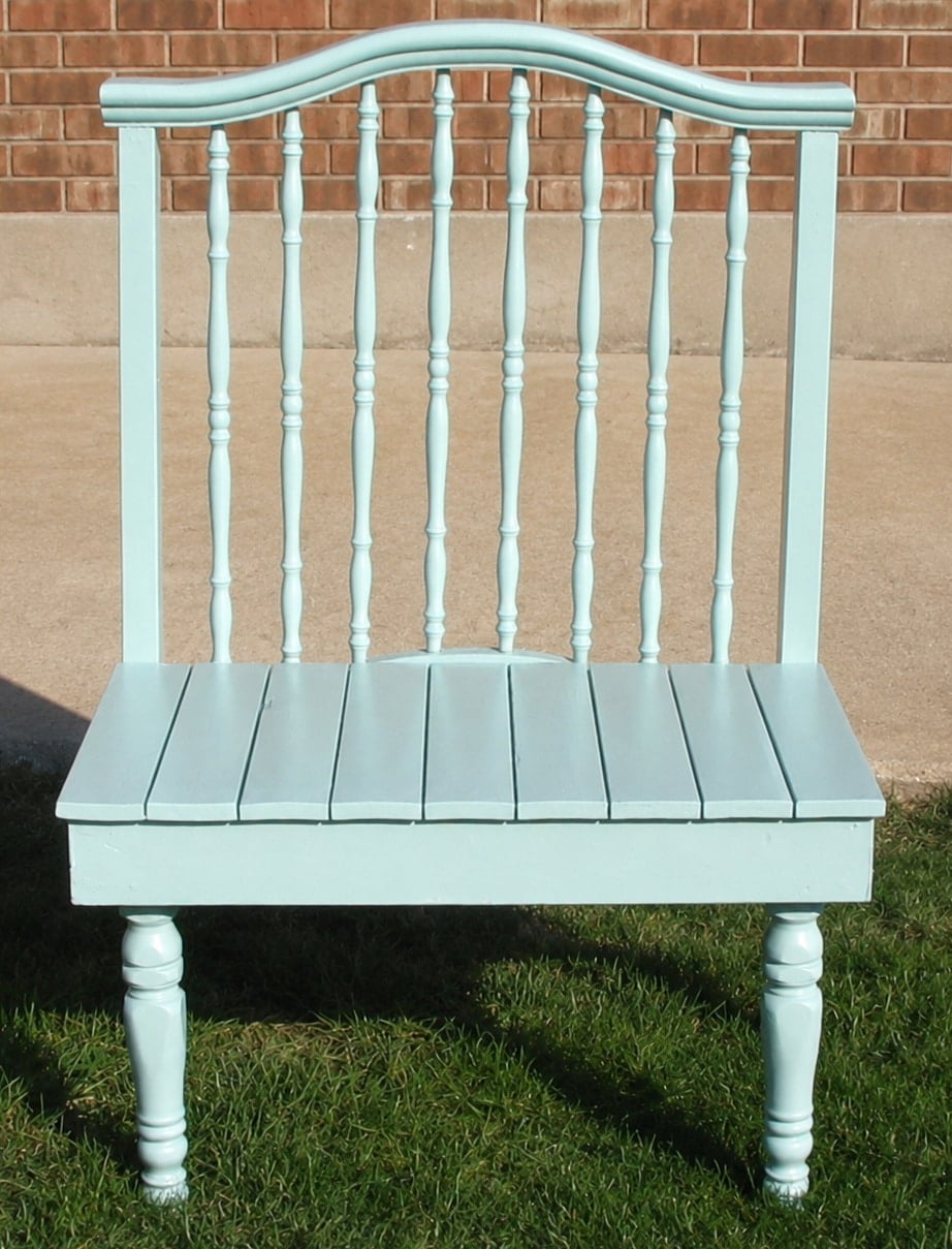 green crib bench sitting in the grass
