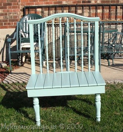 Green bench made out of a baby bed
