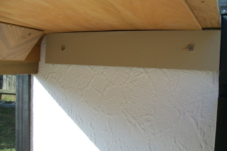 a wooden cleat holding the new top in place