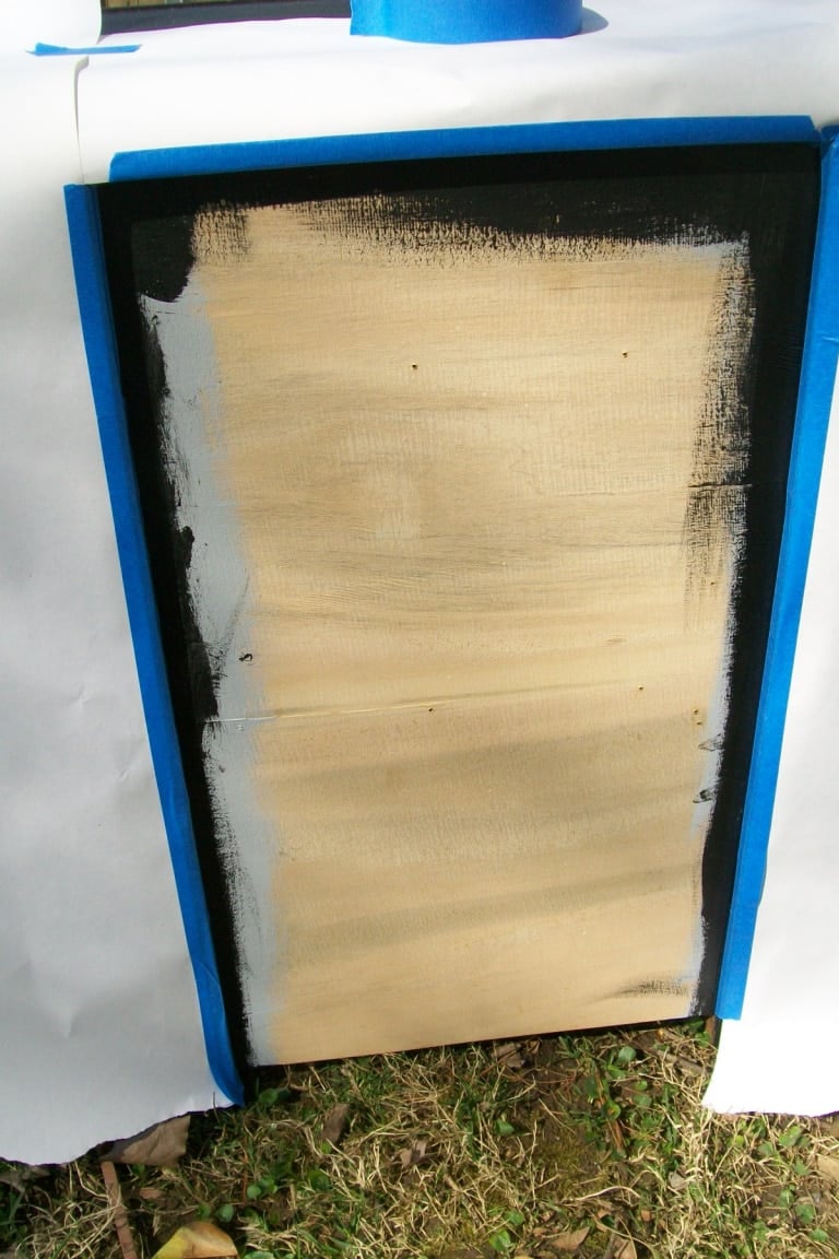 white paper and painter's tape to protect painted vanity from spray adhesive
