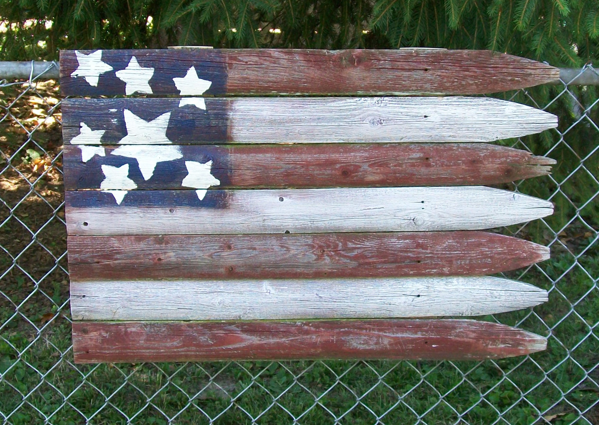 rustic flag hanging on a chain fence