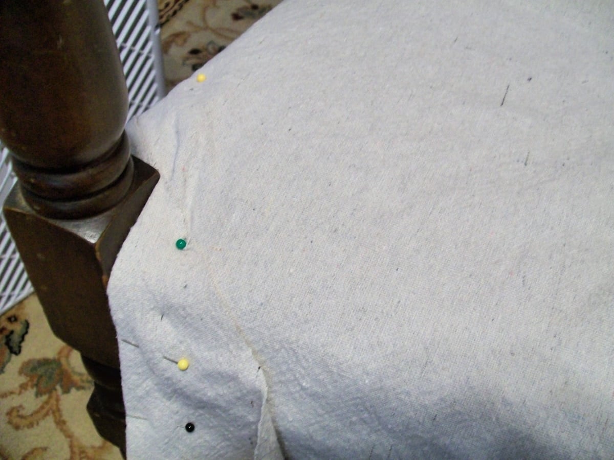 straight pins help hold the drop cloth fabric