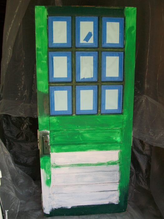 repurposed door bookshelf in paint booth ready for paint sprayer
