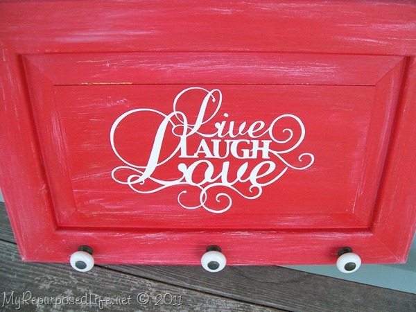 How to make an easy live laugh love sign out of an old microwave cabinet door. Tips on painting and using repurposed hardware knobs. #MyRepurposedLife #repurposed #Cupboard #door #livelaughlove #sign via @repurposedlife