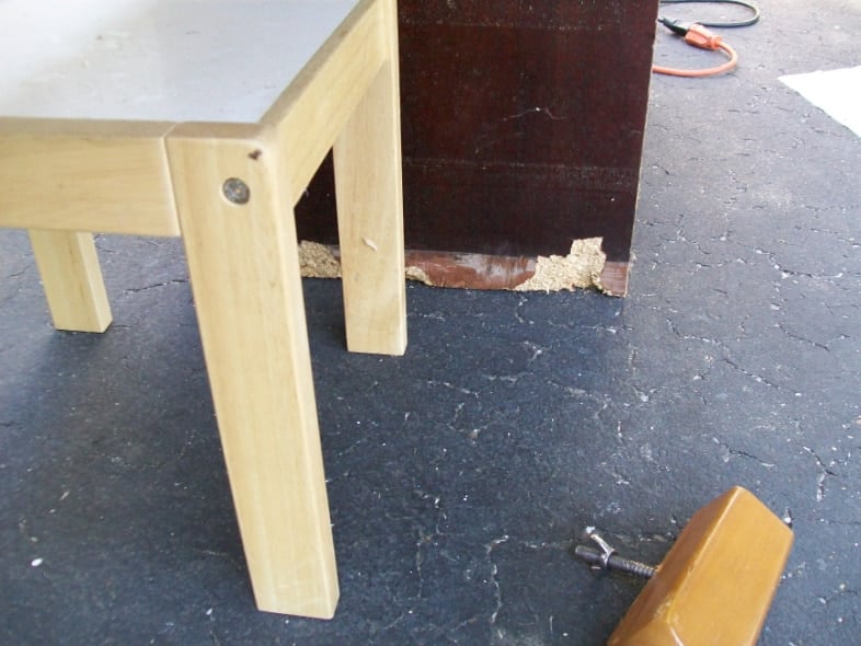 damaged cheap wood on the bottom of the nightstand