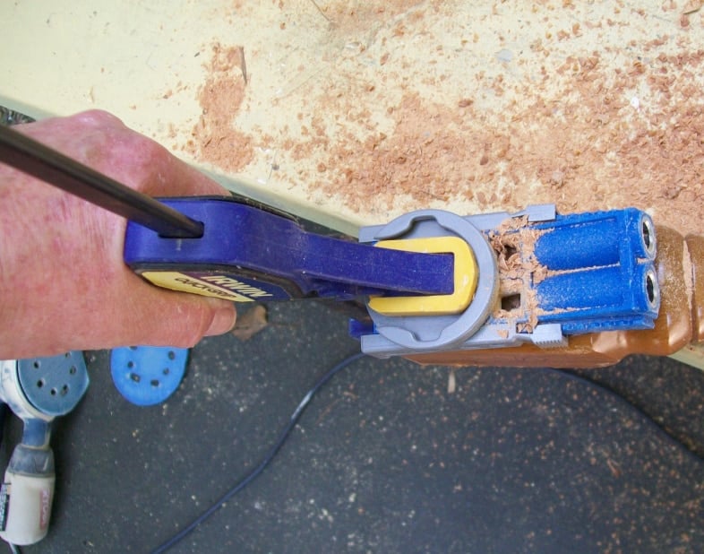 kreg pocket hole jig clamped on to top of reclaimed table leg