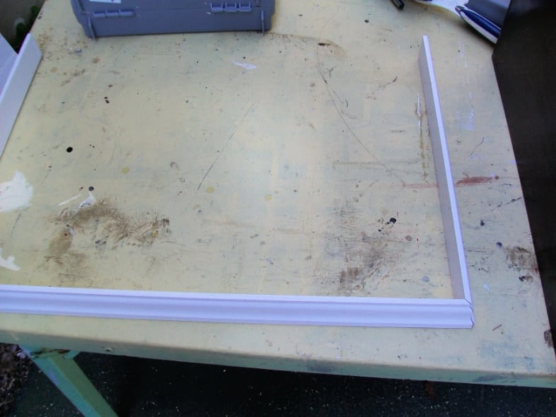 three pieces of trim laying on a work table