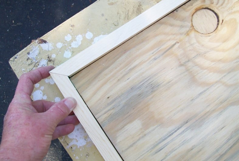 woman holding a corner mitered joint together