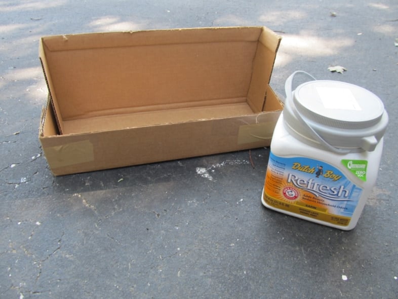 a cardboard box and a gallon of wall paint