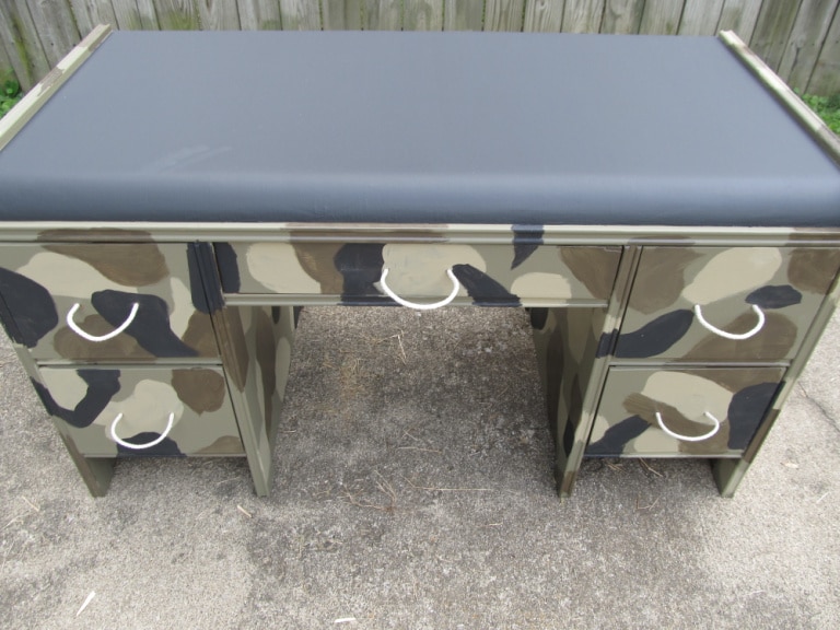 closeup of smaller camo desk with rope handles and a chalkboard top
