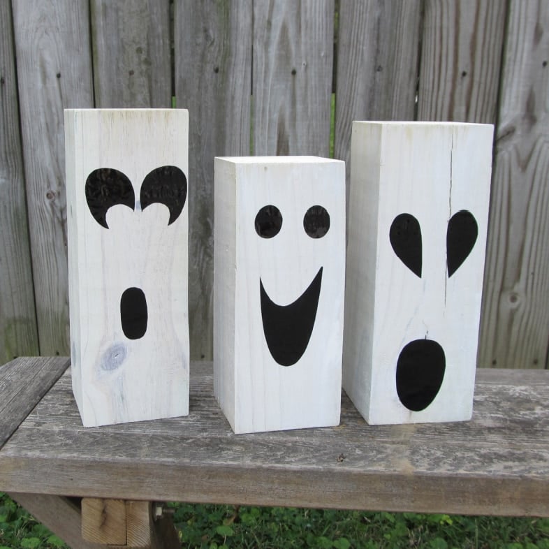 closeup of white wooden ghost faces