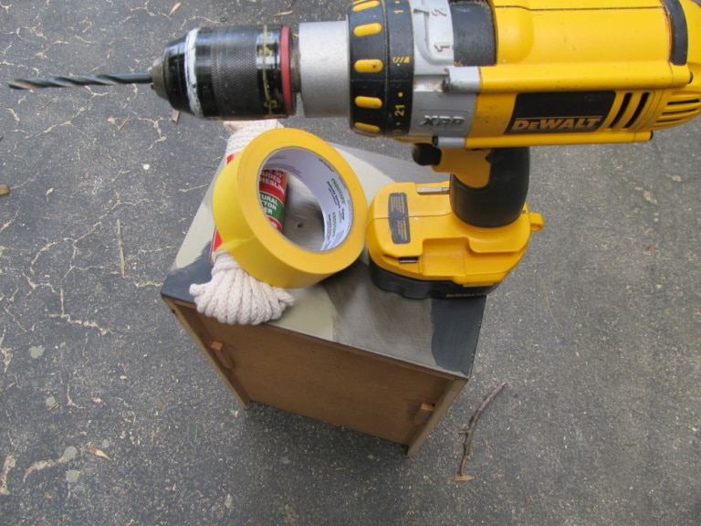 drill, rope, painter's tape atop a drawer