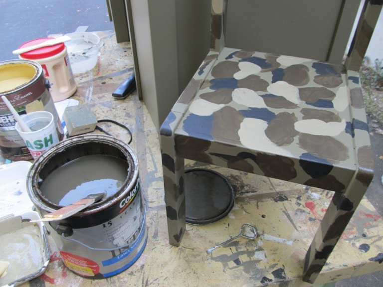 painting a camouflage pattern on a small chair