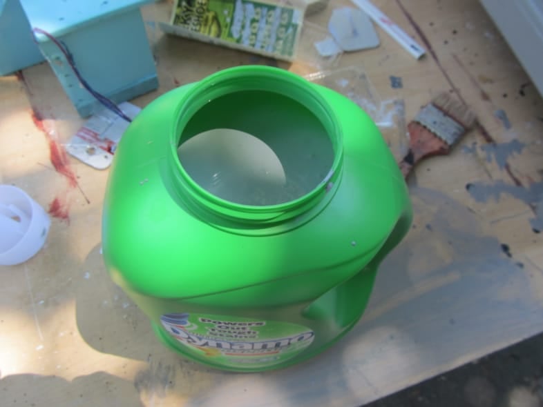 green laundry jug full of paint