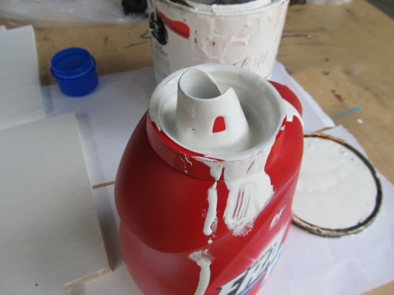 messy paint in the neck of the laundry jug