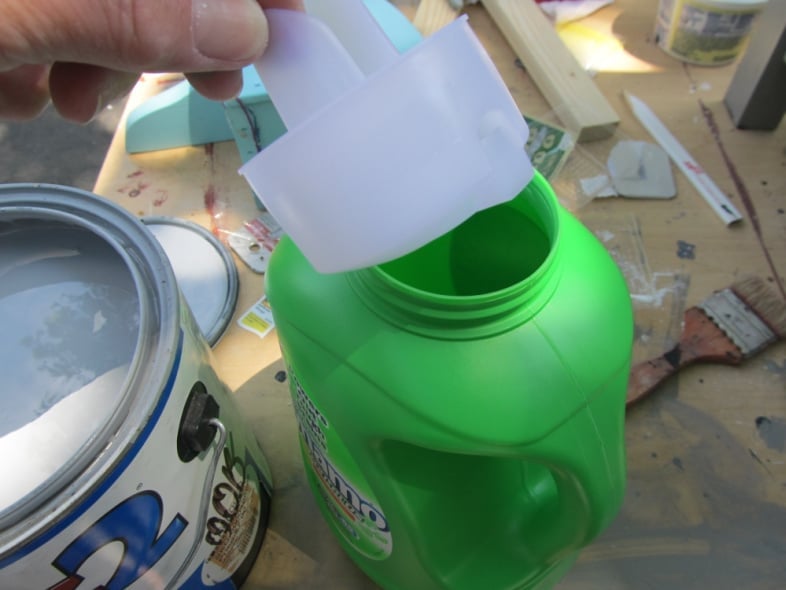 removing the spout from a green laundry jug
