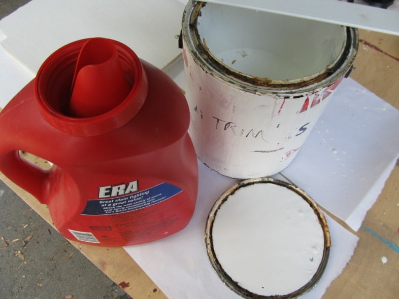 rusted paint can and an ERA laundry jug