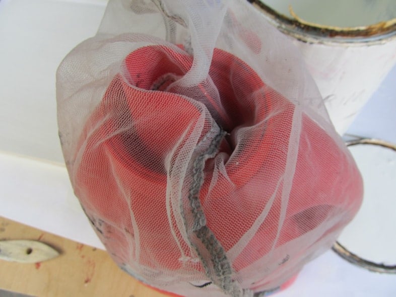 ERA laundry jub with a mesh paint strainer straining paint