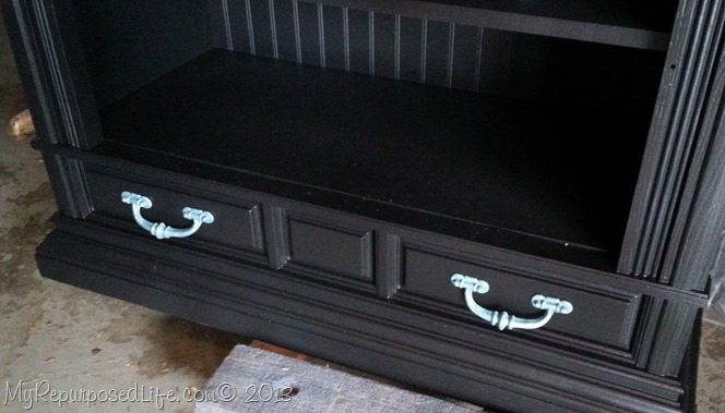 black cabinet with turquoise hardware