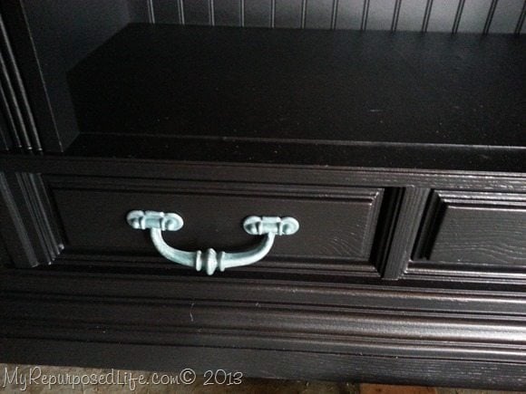 Turquoise hardware on black cabinet