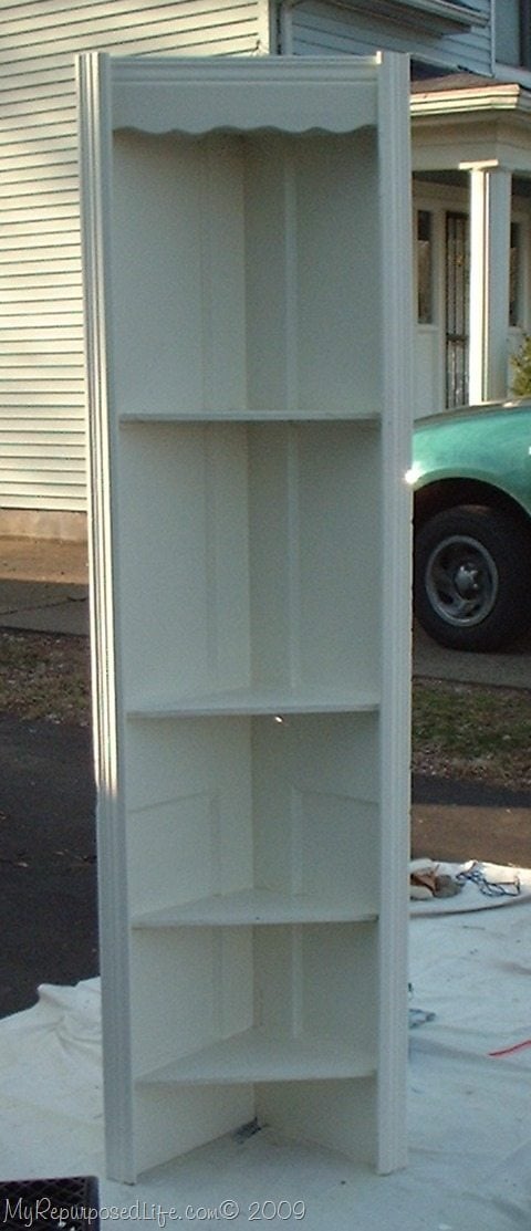 repurposed door into a corner shelf