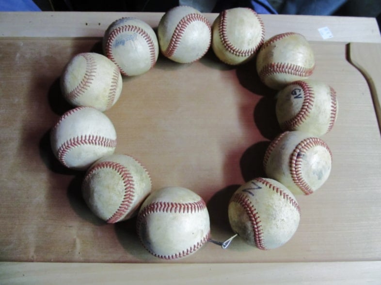 eleven baseballs in a circle secure with wire