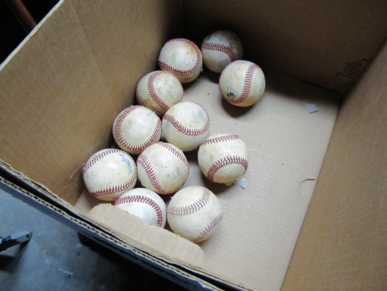 old baseballs in a cardboard box