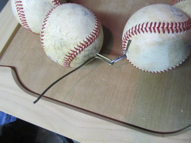wire twisted to hold baseballs on
