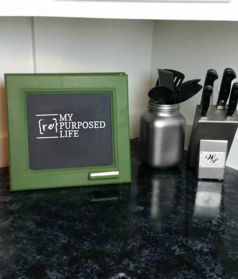 small green chalkboard easel sitting on a kitchen counter