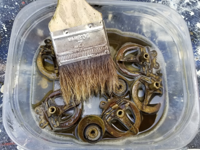 paint brush cleans crevices of hardware