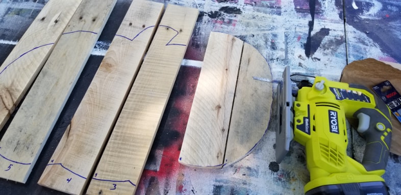 cut pallet boards with jigsaw to make fall sign