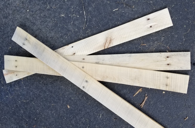 four rustic pallet boards laying on the driveway