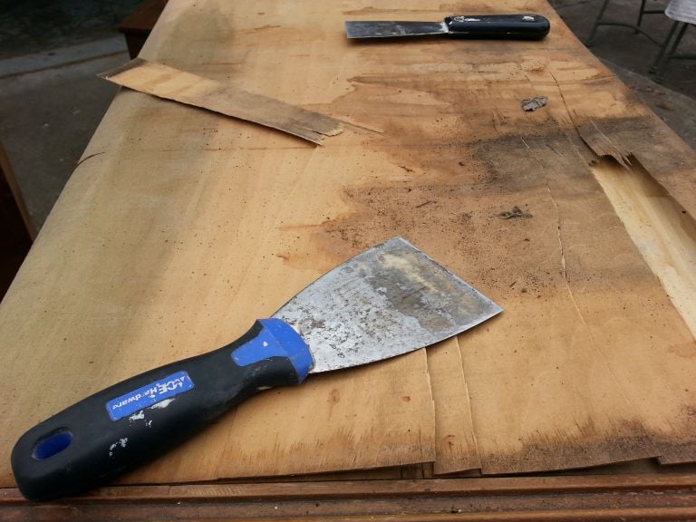 removing bad veneer with a putty knife