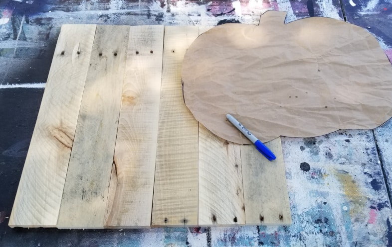 trace pumpkin shape onto pallet boards with a sharpie