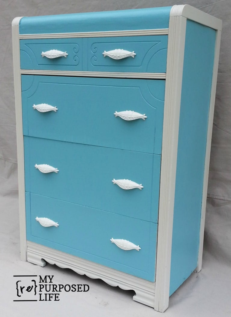 blue dresser with white tirm and white hardware