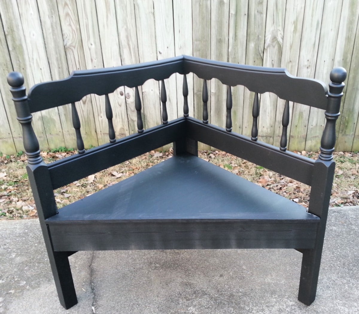 black corner bench made from a headboard