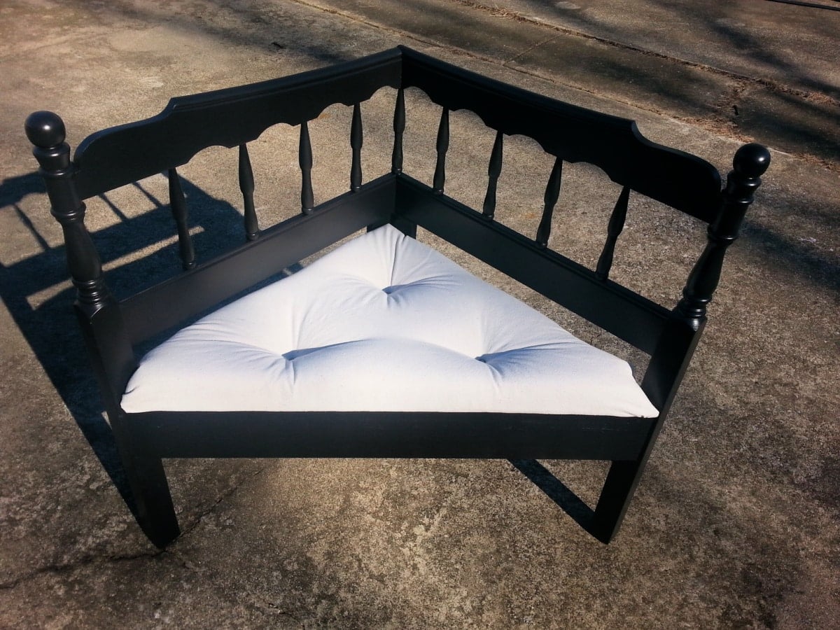 black corner bench with a button tufted upholstered seat