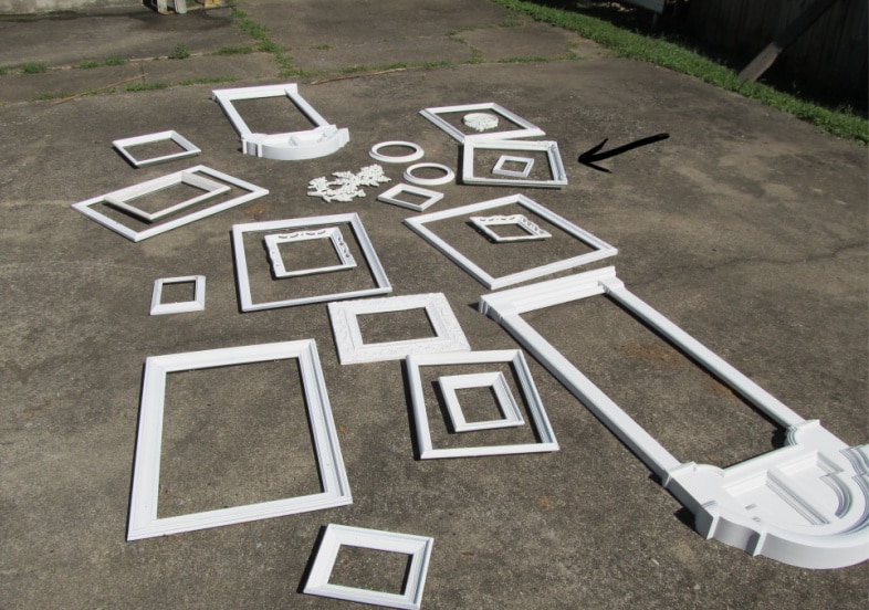 20 white frames laying on a driveway