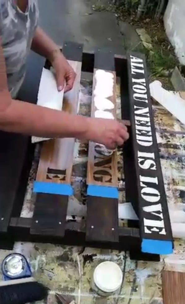 woman painting pallet stencil