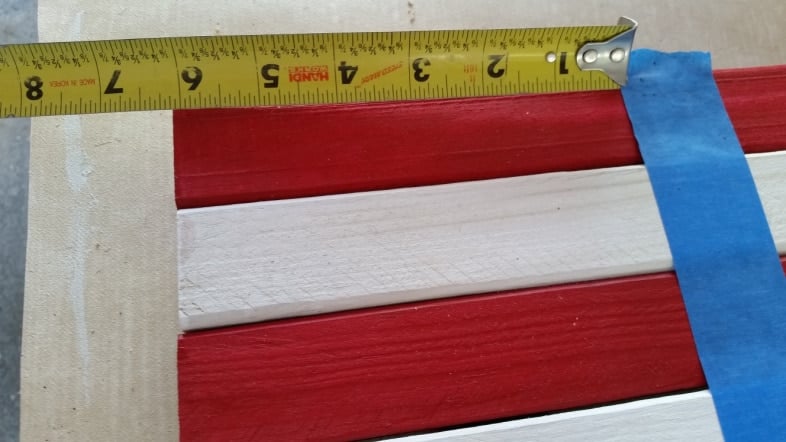 tape measure and painter's tape to place star stencil