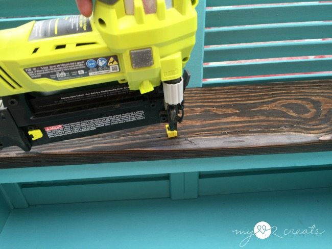 nailing on stained shelf boards, repurposed from old deck wood