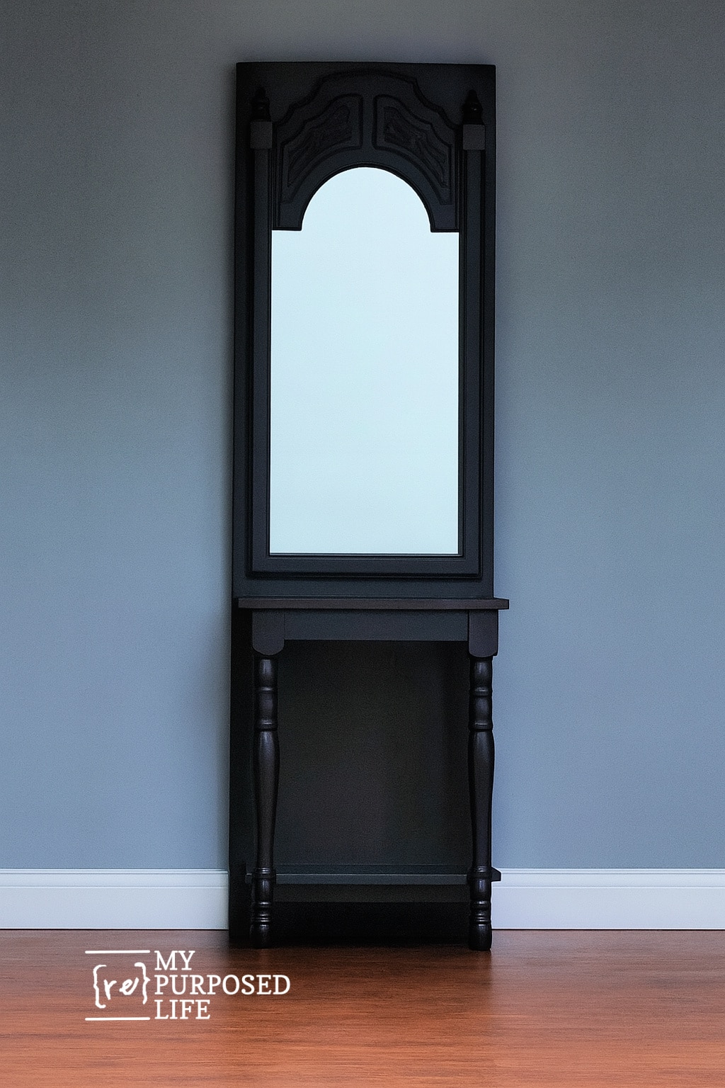pretty black DIY entryway table made from a door and salvaged bits and pieces