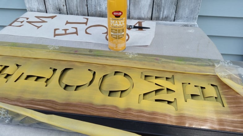 spray painting a stencil on a shutter