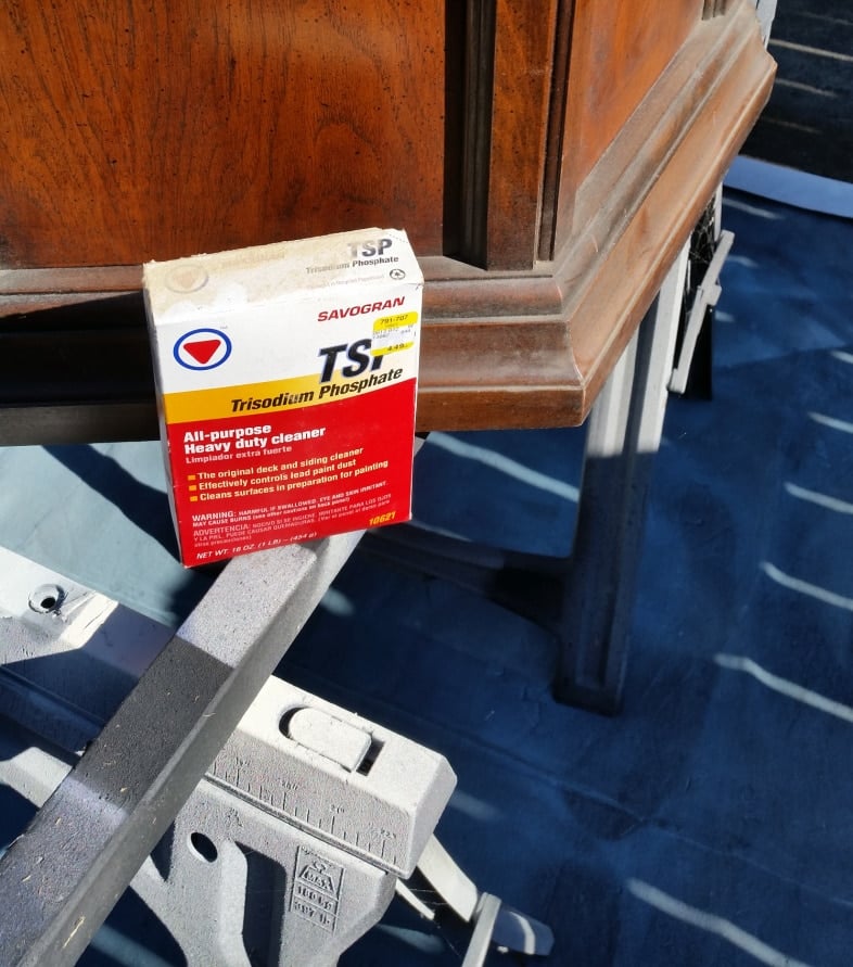 a box of TSP powder next to a dirty thrift store table