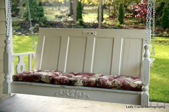 an old door is used to make a great porch swing
