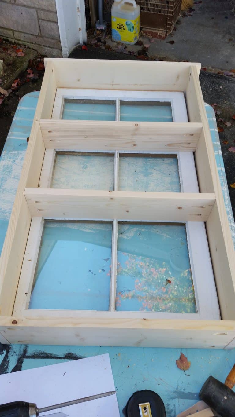 affixing shelves to window cabinet