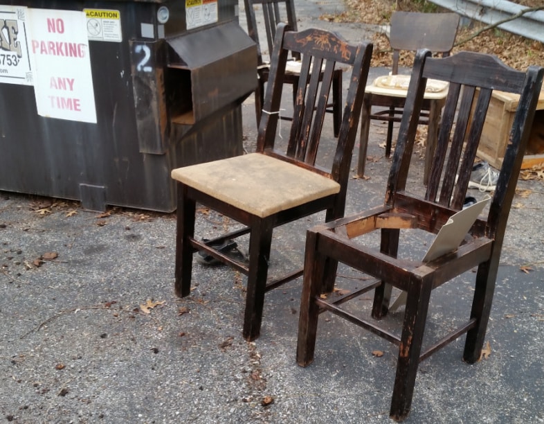 chairs beside a dumpster