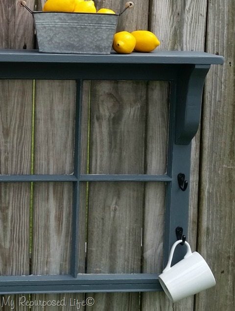 gray window shelf with coffee cup and lemons