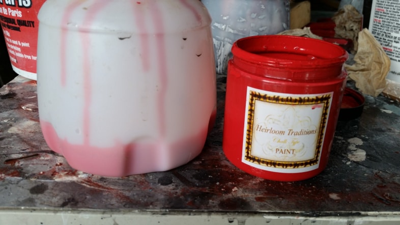 small container of red paint