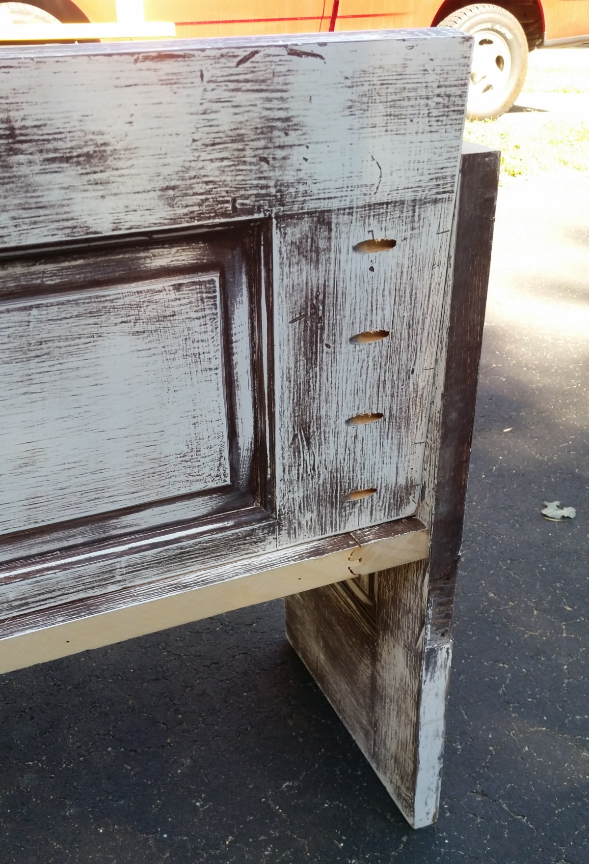 slanted back on a door bench